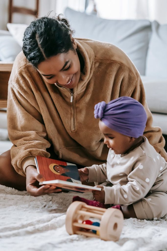 mother and baby girl reading a book